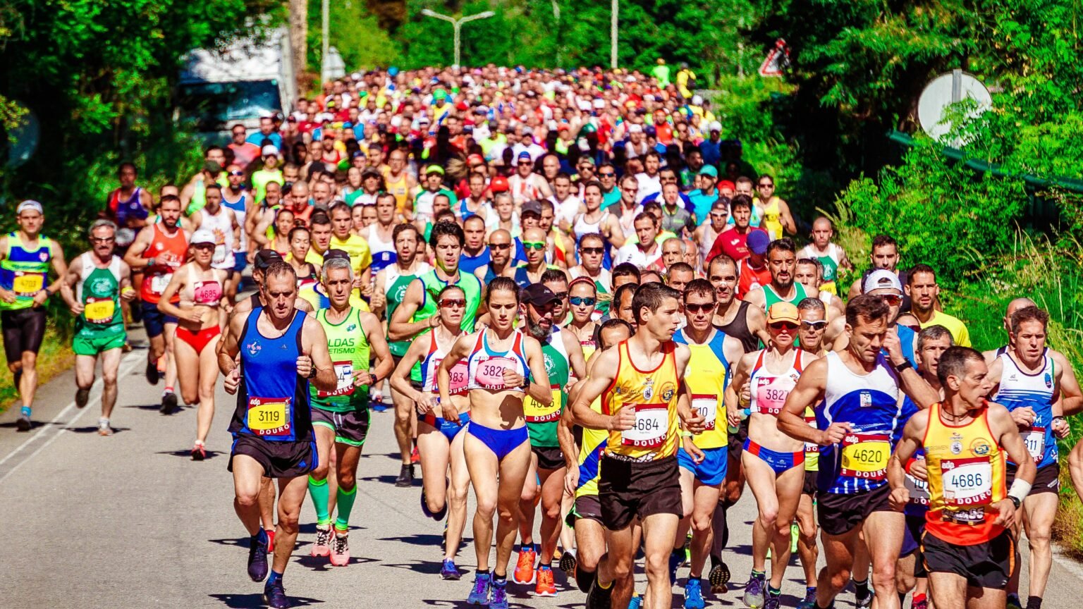 Energetic marathon runners competing on a sunny day, showcasing perseverance and community spirit.