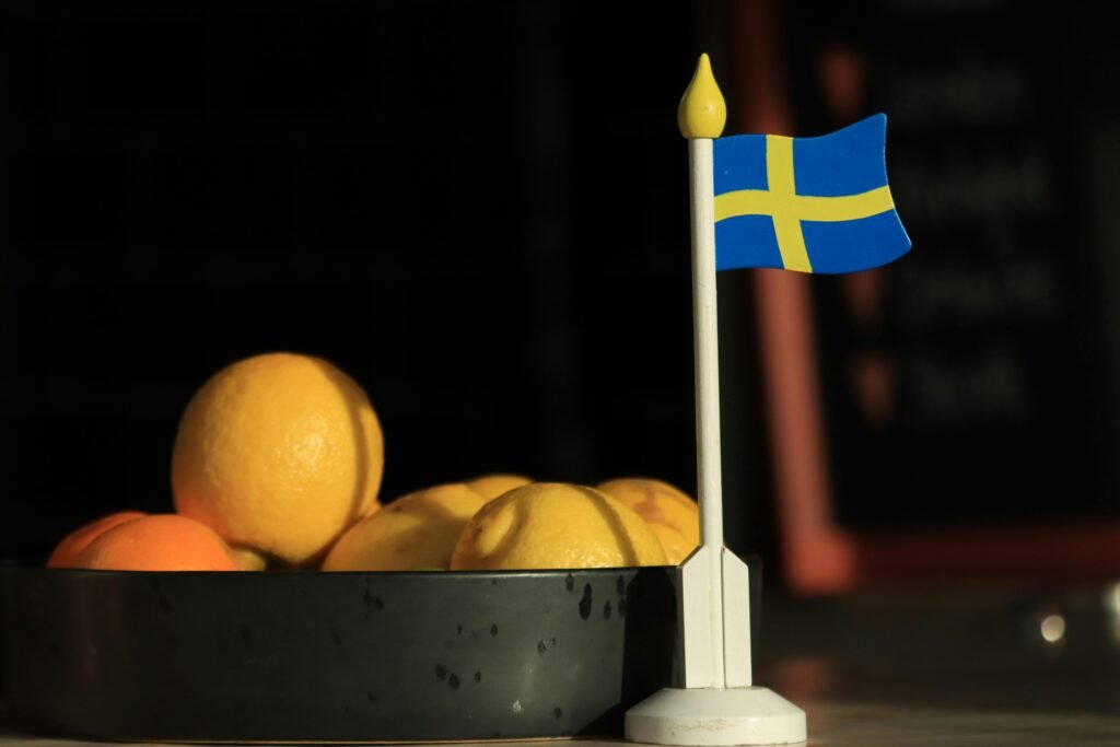 A bowl of lemons and oranges with a Swedish flag on display in Jönköping, Sweden.