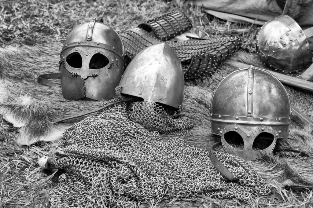 Close-up of historical medieval helmets and art.